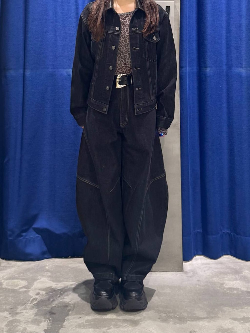 ブラック系のデニムパンツ、ブラック系のデニムジャケット、ブラック系のブーツを着用したレディースの夏コーディネートの2枚目の写真