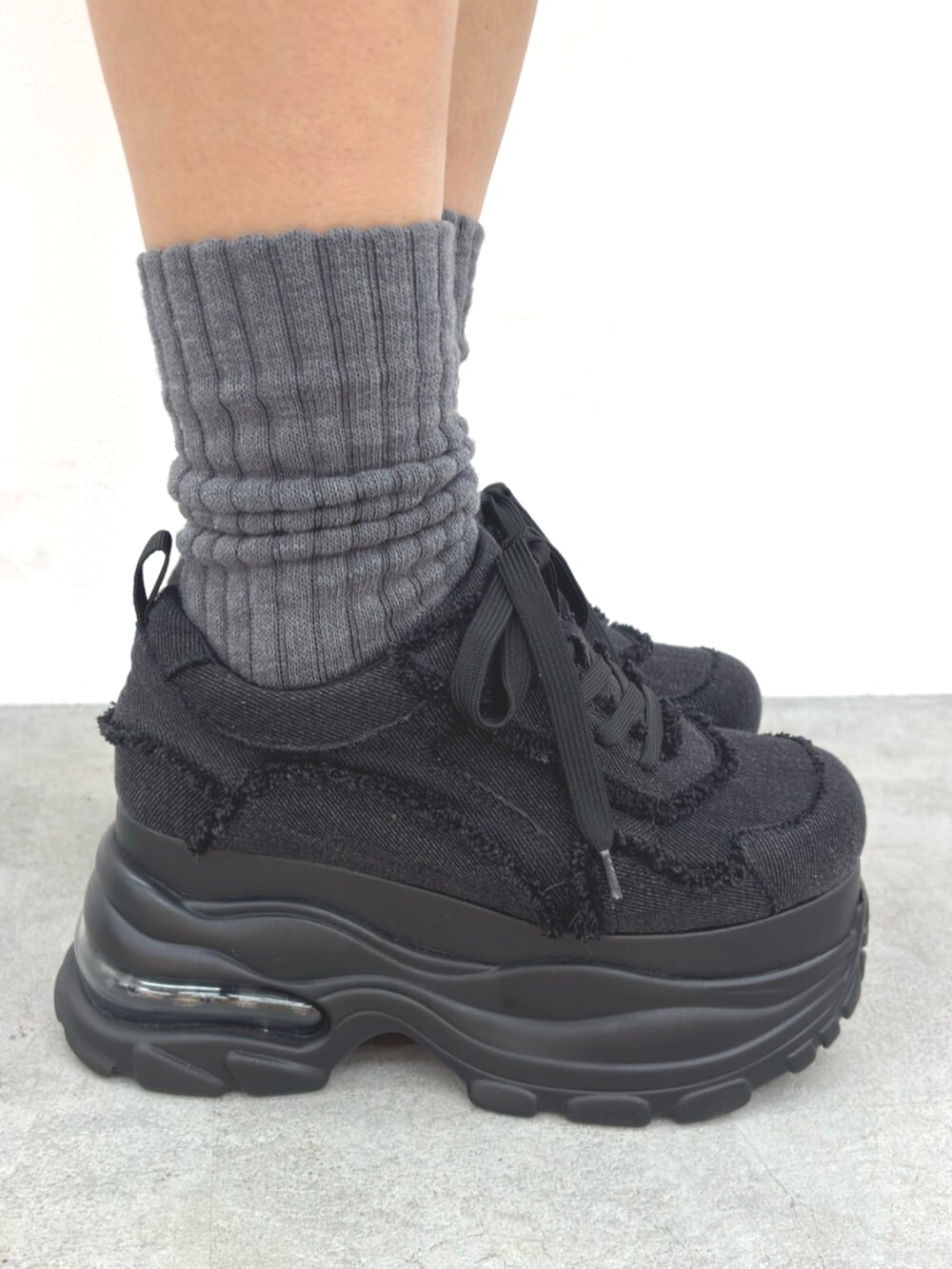 ブラック系のスウェットパンツ、ブラック系のスニーカー、ブラック系のTシャツ/カットソーを着用したレディースの冬コーディネートの5枚目の写真