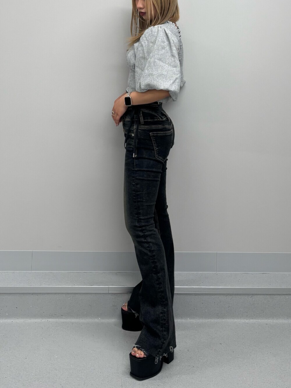 グレー系のTシャツ/カットソー、ブルー系のデニムパンツ、ブラック系のサンダルを着用したレディースの春コーディネートの2枚目の写真