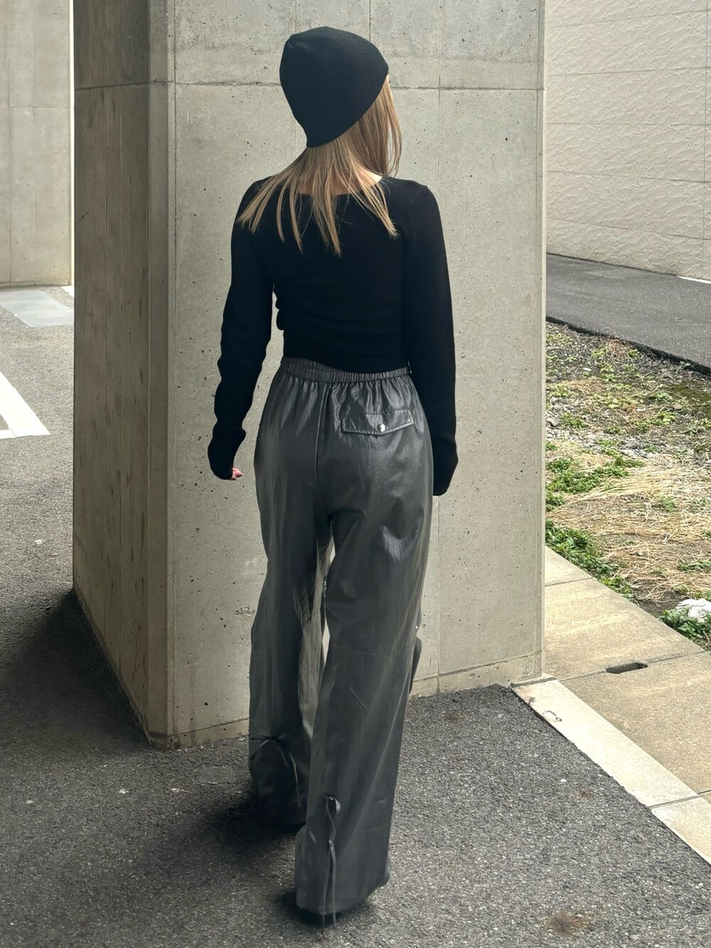 グレー系のその他パンツ、ブラック系のニット/セーター、ブラック系のブーツを着用したレディースの冬コーディネートの3枚目の写真