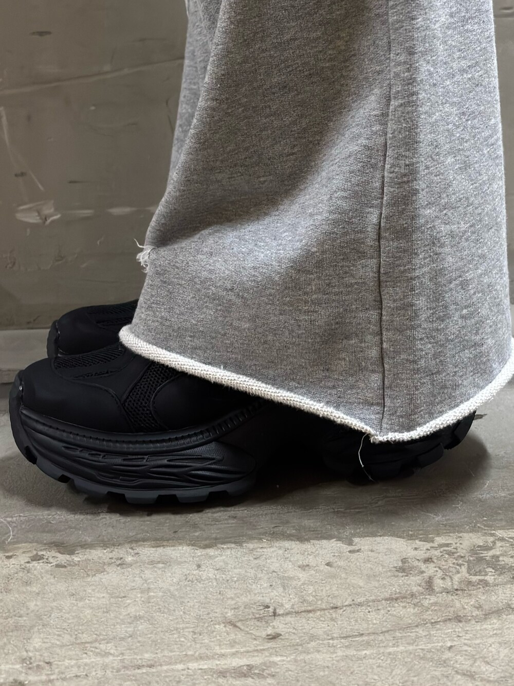 ブラウン系のデニムジャケット、グレー系のスウェットパンツ、ブラック系のスニーカーを着用したレディースの秋コーディネートの5枚目の写真