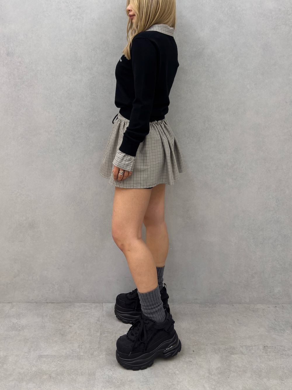 ブラック系のシャツ/ブラウス、ブラック系のスカート、ブラック系のスニーカーを着用したレディースの冬コーディネートの2枚目の写真