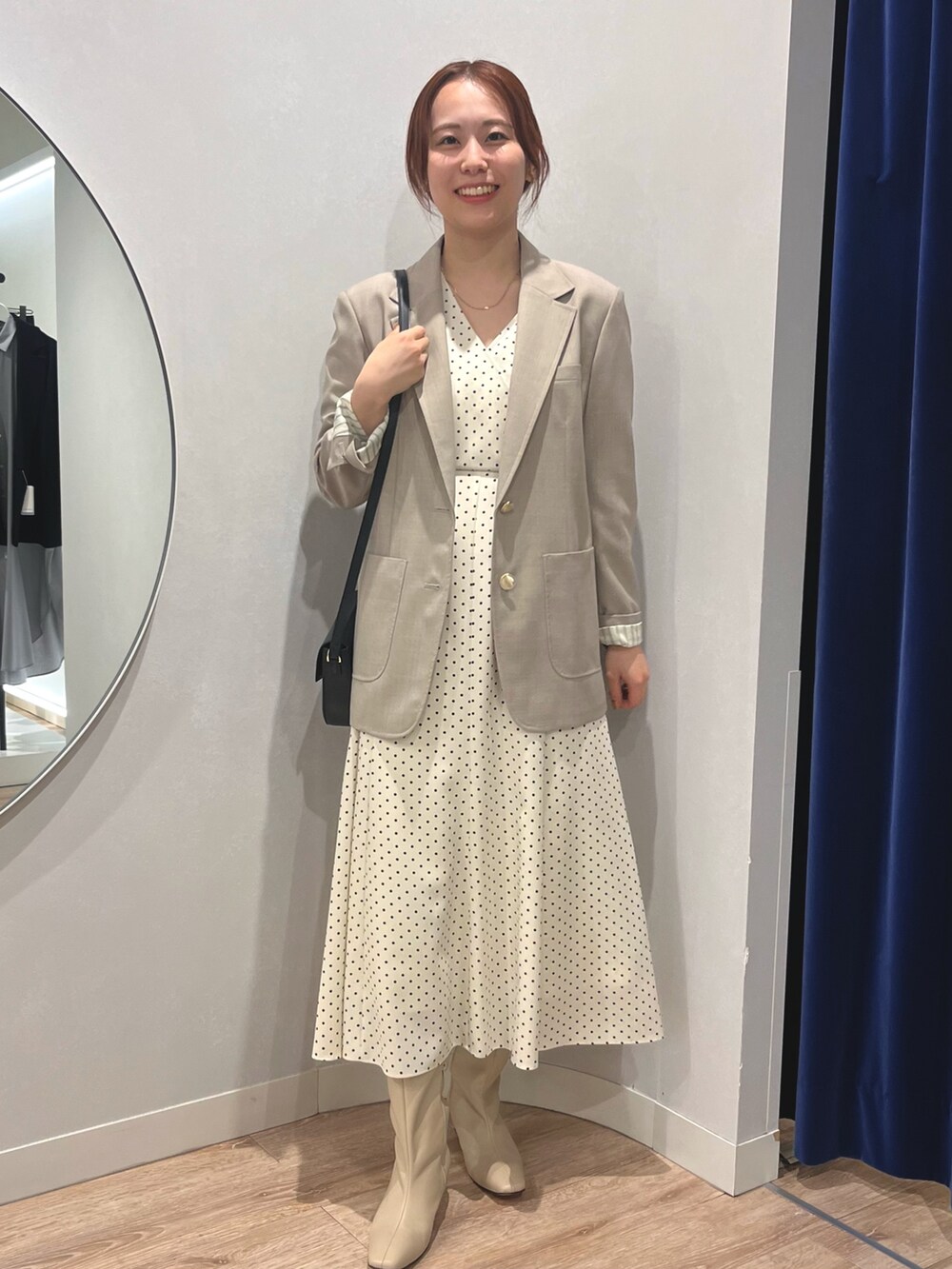 ベージュ系のテーラードジャケット、ホワイト系のワンピースを着用したレディースの秋コーディネートの6枚目の写真