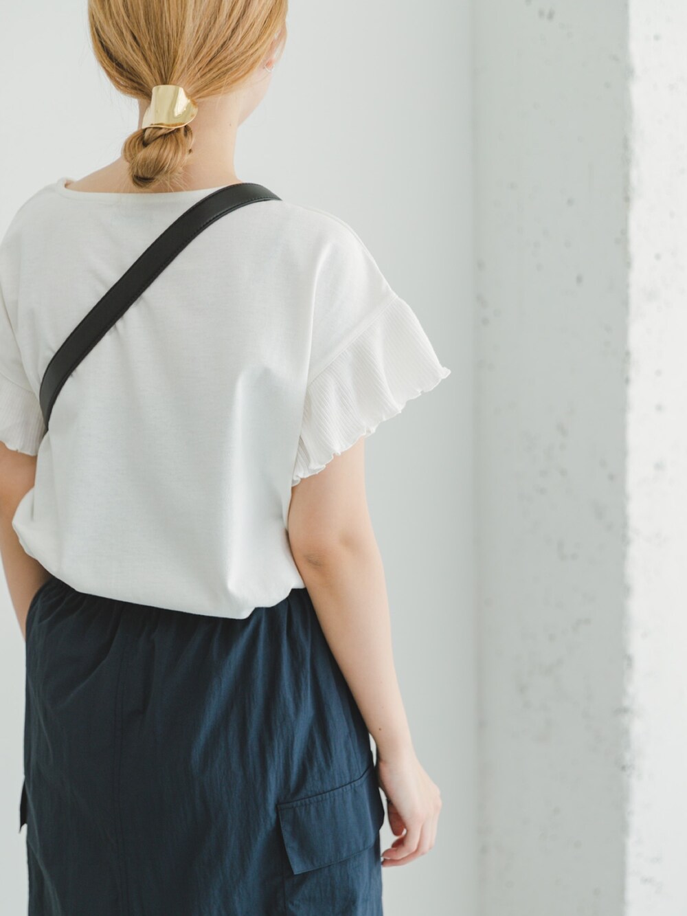 ブルー系のスカート、ホワイト系のTシャツ/カットソー、ブラック系のショルダーバッグを着用したレディースの夏コーディネートの3枚目の写真