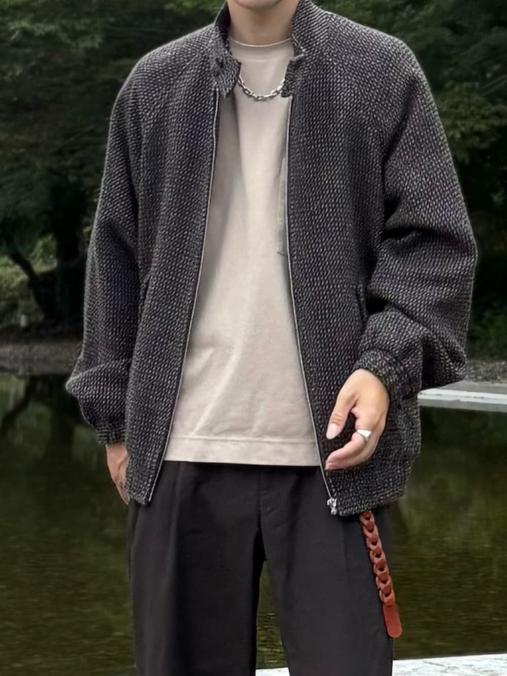 ベージュ系のTシャツ/カットソー、ブラウン系のブルゾン、ブラウン系のスラックスを着用したメンズの秋コーディネートの5枚目の写真