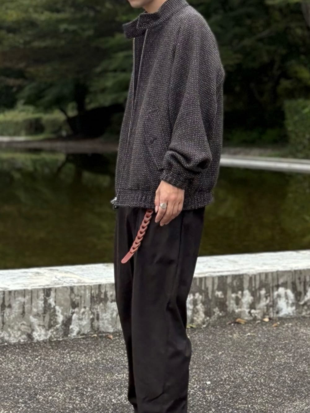 ベージュ系のTシャツ/カットソー、ブラウン系のブルゾン、ブラウン系のスラックスを着用したメンズの秋コーディネートの4枚目の写真