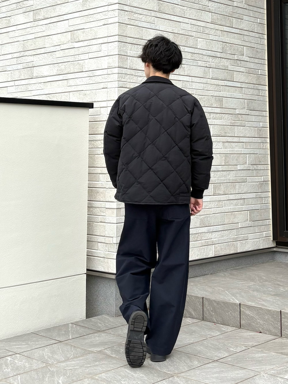 ブラック系のダウンジャケット/コート、ブラック系のシューズを着用したメンズの冬コーディネートの4枚目の写真