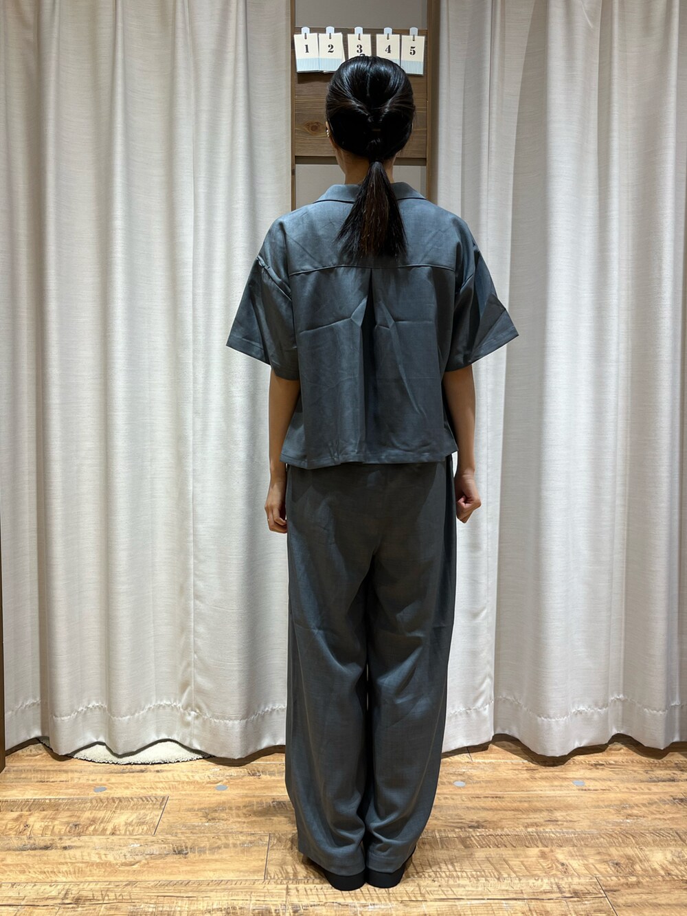 グレー系のパンツ、グレー系のシャツ/ブラウス、ブラック系のローファーを着用したレディースの夏コーディネートの3枚目の写真