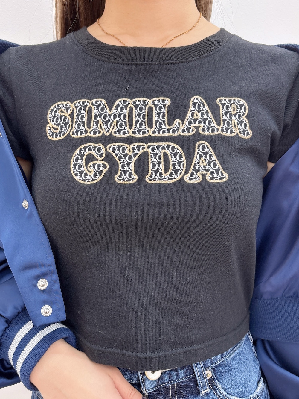 ブラック系のTシャツ/カットソー、ブルー系のブルゾン、ブルー系のデニムパンツを着用したレディースの冬コーディネートの6枚目の写真