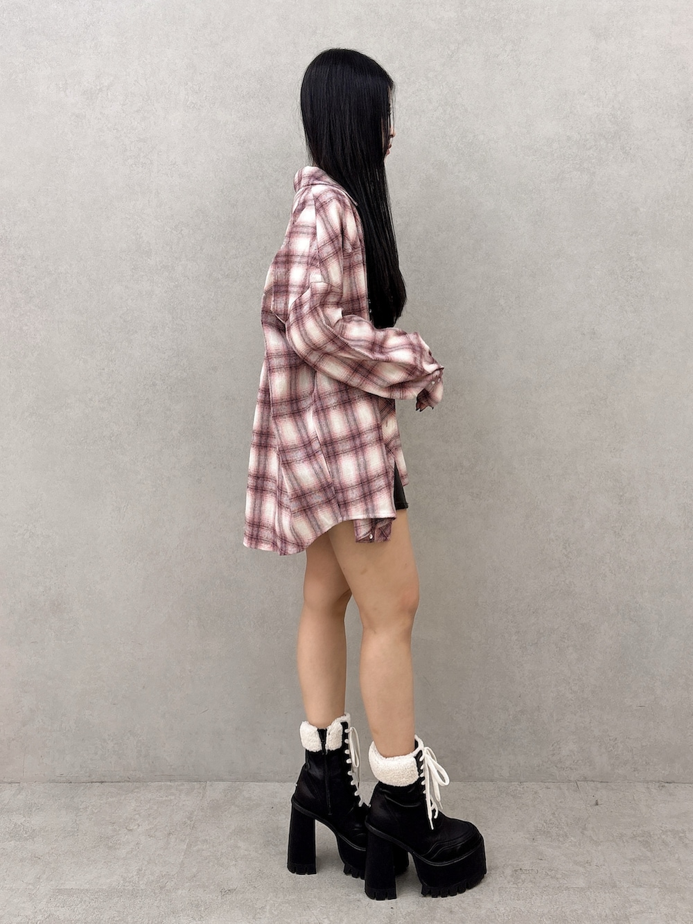 ホワイト系のニット/セーター、ピンク系のシャツ/ブラウス、ブラック系のスカートを着用したレディースの冬コーディネートの2枚目の写真