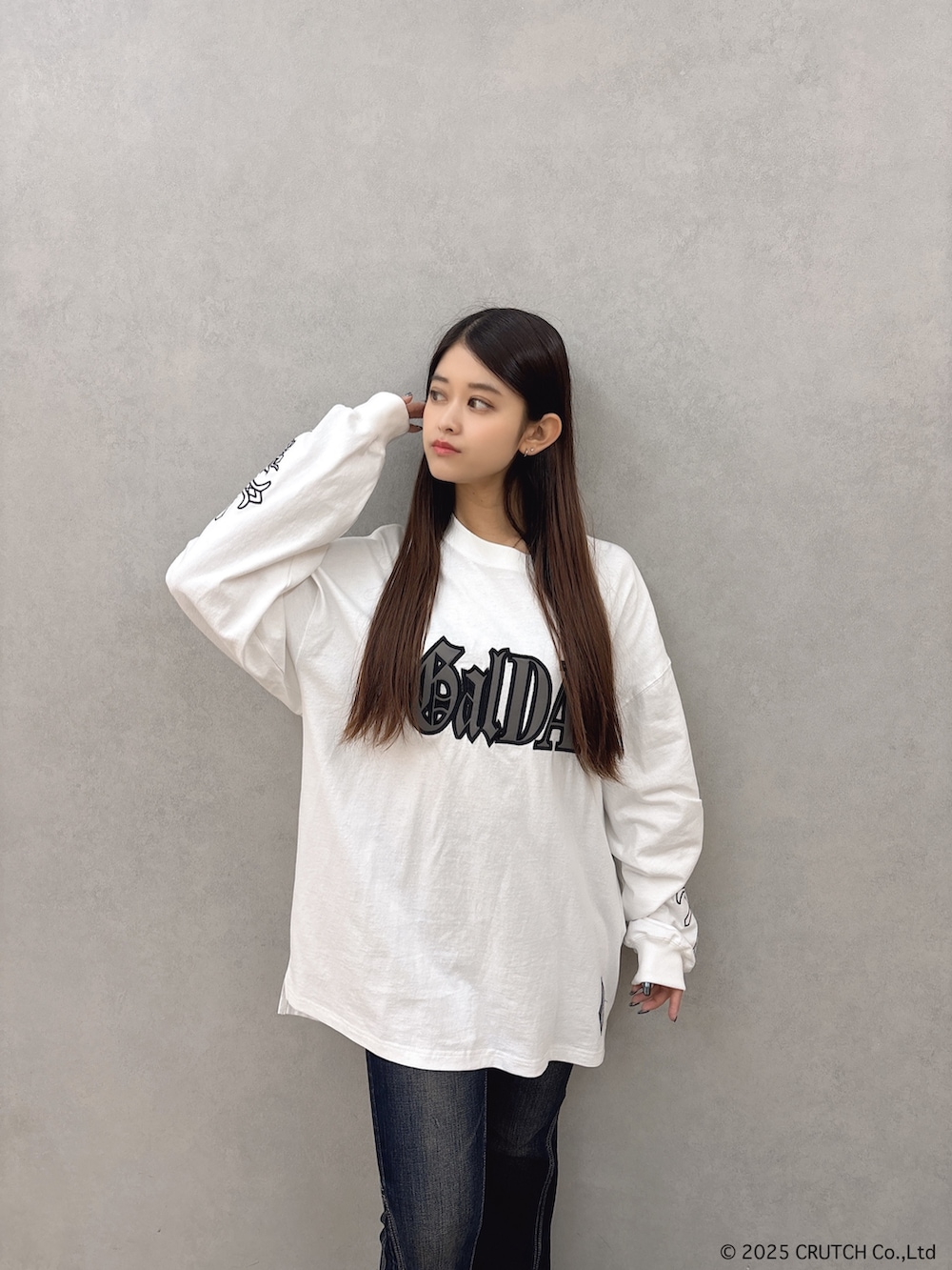 ホワイト系のTシャツ/カットソー、ブルー系のデニムパンツ、ブラック系のブーツを着用したレディースの秋コーディネートの4枚目の写真