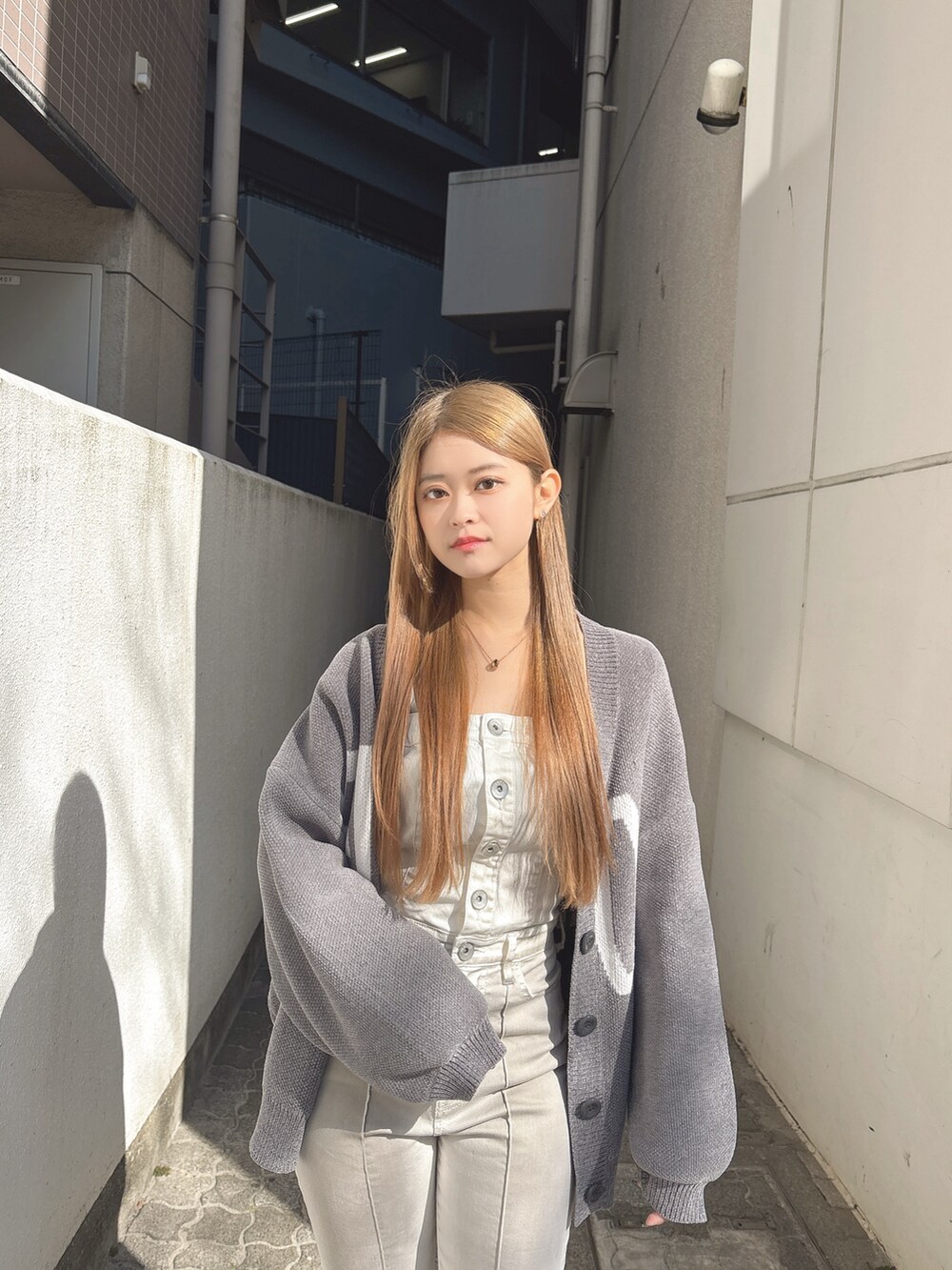ホワイト系のつなぎ/オールインワン、グレー系のカーディガン/ボレロ、ブラック系のパンプスを着用したレディースの冬コーディネートの4枚目の写真