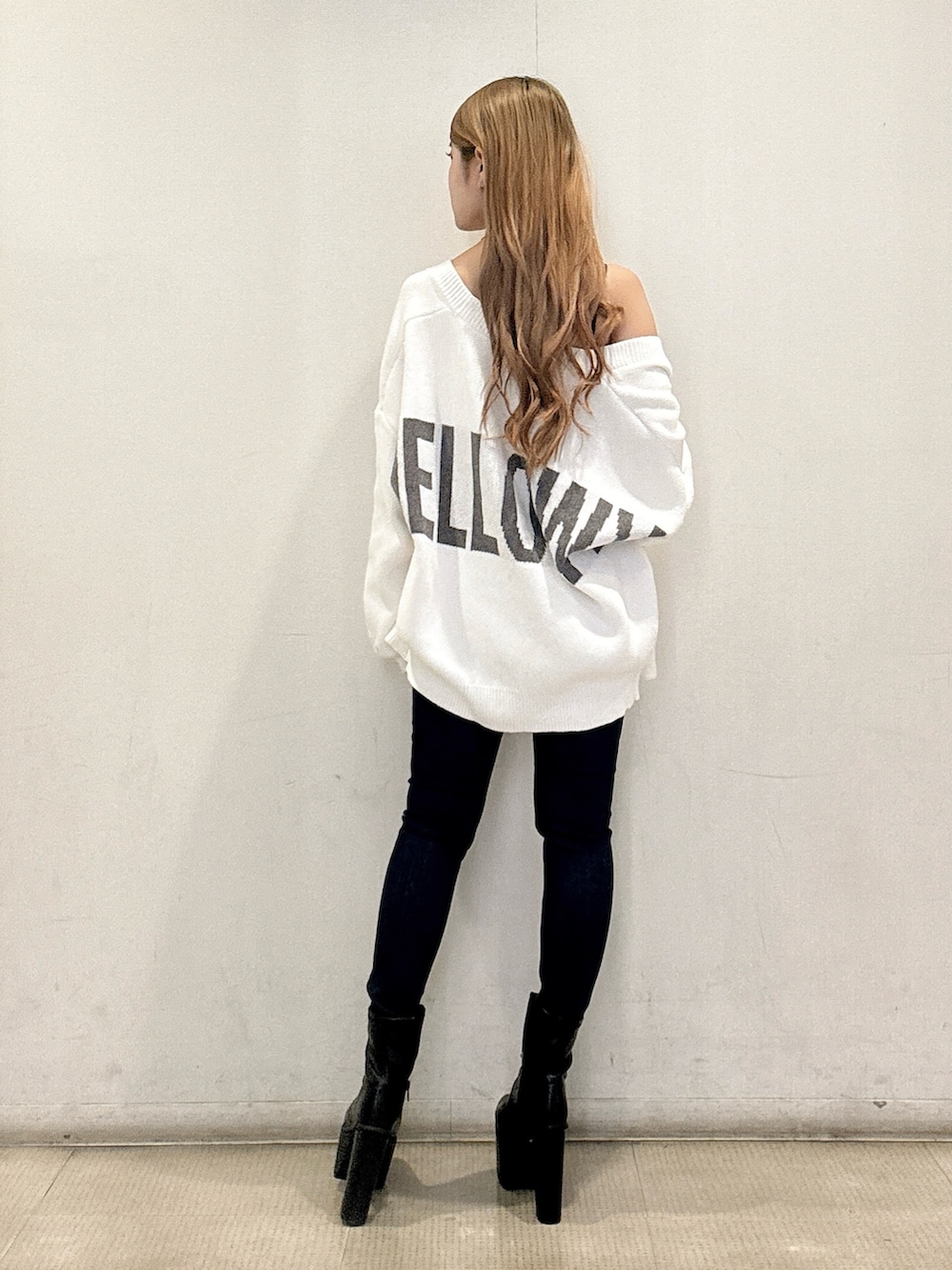 ブラック系のキャミソール、ホワイト系のカーディガン/ボレロ、ブルー系のデニムパンツを着用したレディースの春コーディネートの3枚目の写真