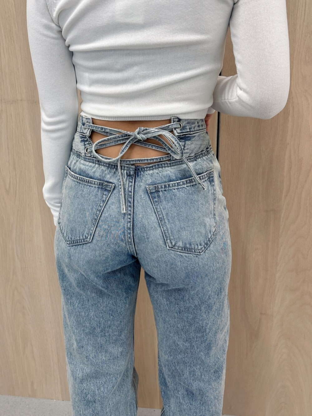 ブラック系のブーツ、ブラック系のTシャツ/カットソー、ブルー系のデニムパンツを着用したレディースの春コーディネートの8枚目の写真