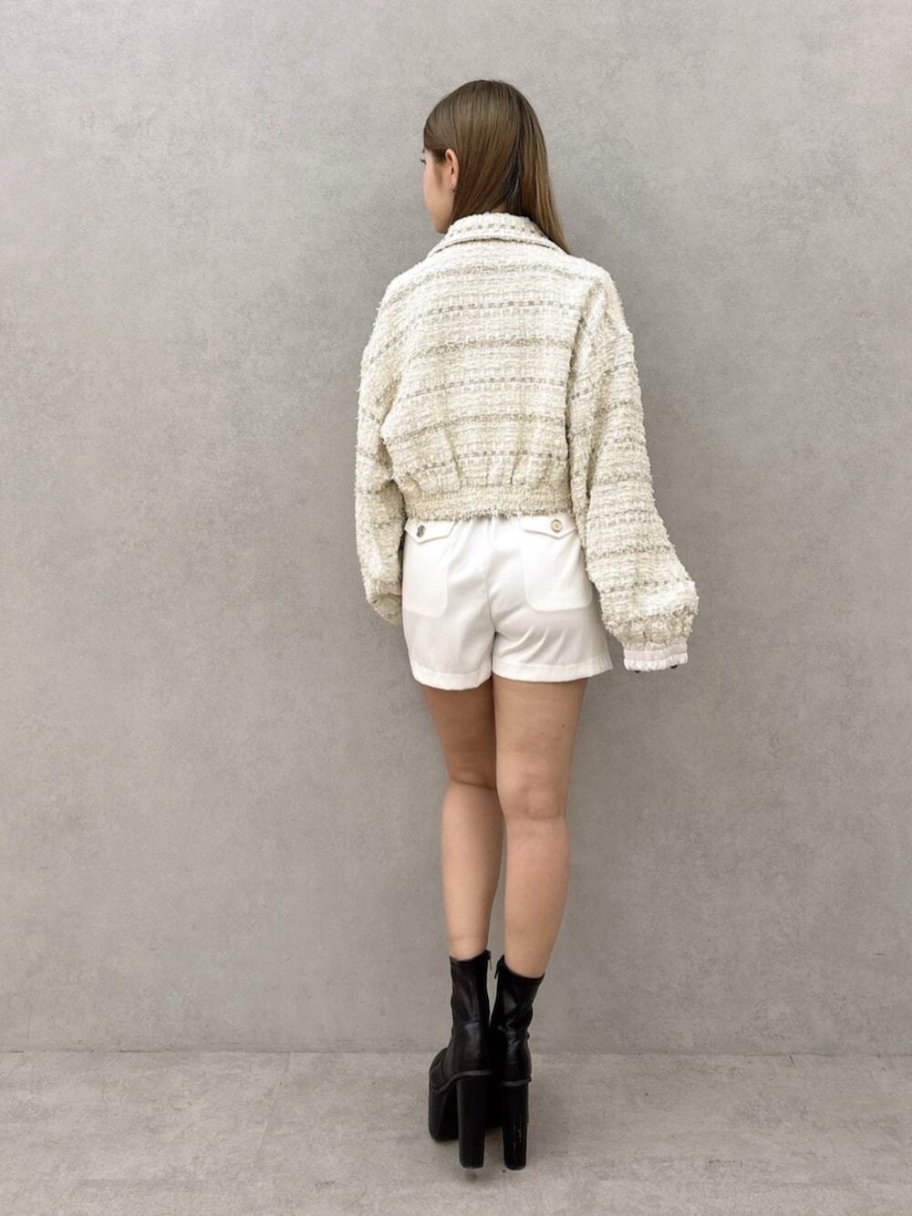 ブラック系のブーツ、ホワイト系のつなぎ/オールインワン、ホワイト系のその他アウターを着用したレディースの冬コーディネートの4枚目の写真