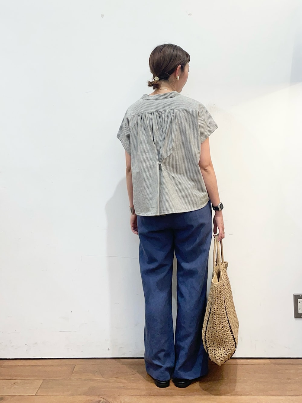 ブラック系のシャツ/ブラウス、ブルー系のその他パンツ、ベージュ系のトートバッグを着用したレディースの夏コーディネートの4枚目の写真