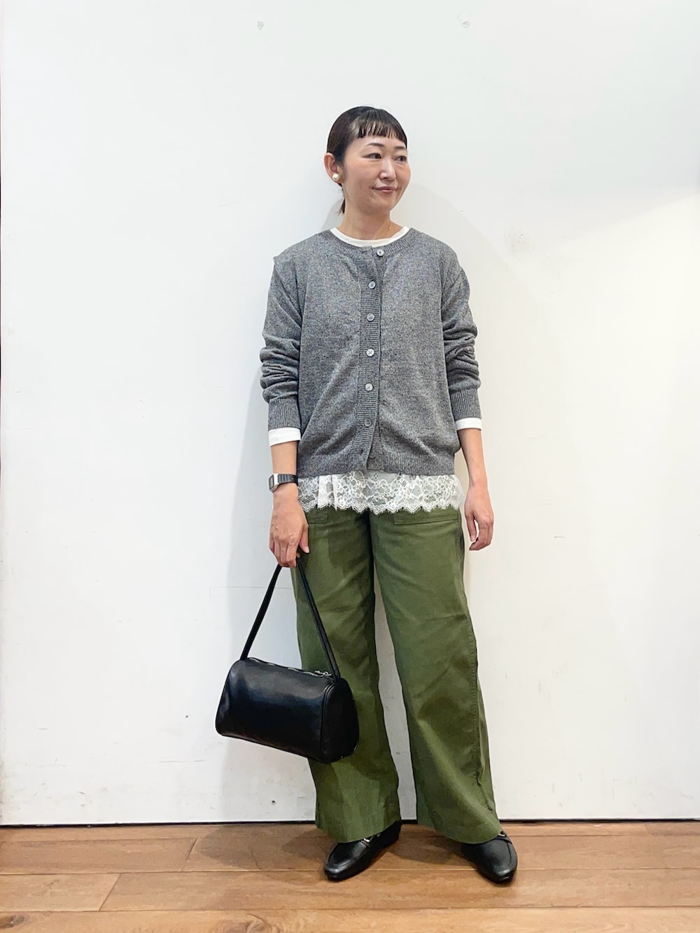 ホワイト系のTシャツ/カットソー、グリーン系のその他パンツ、グレー系のカーディガン/ボレロを着用したレディースの秋コーディネートの3枚目の写真