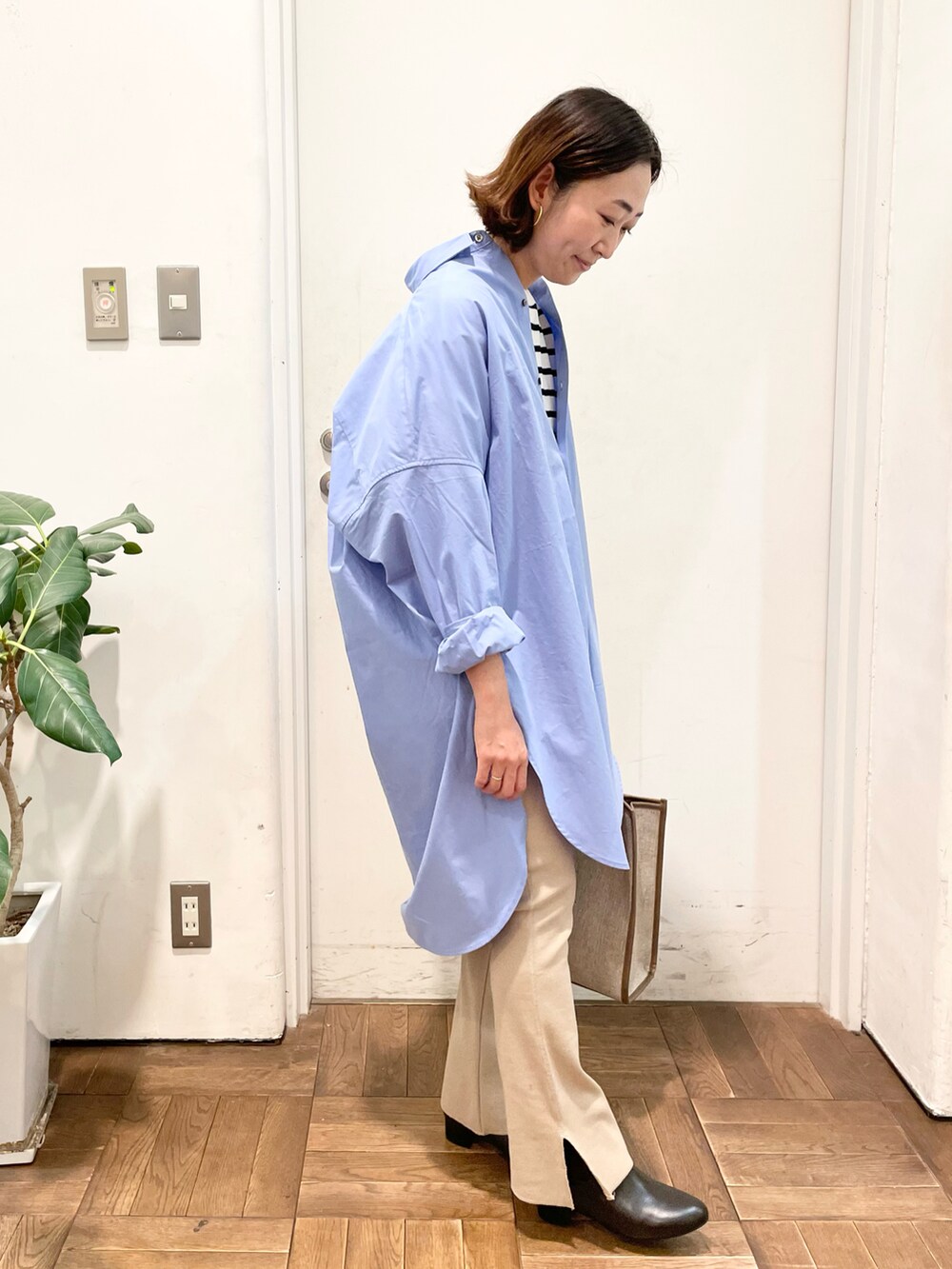 ブラック系のTシャツ/カットソー、ブルー系のシャツ/ブラウス、ベージュ系のトートバッグを着用したレディースの冬コーディネートの3枚目の写真