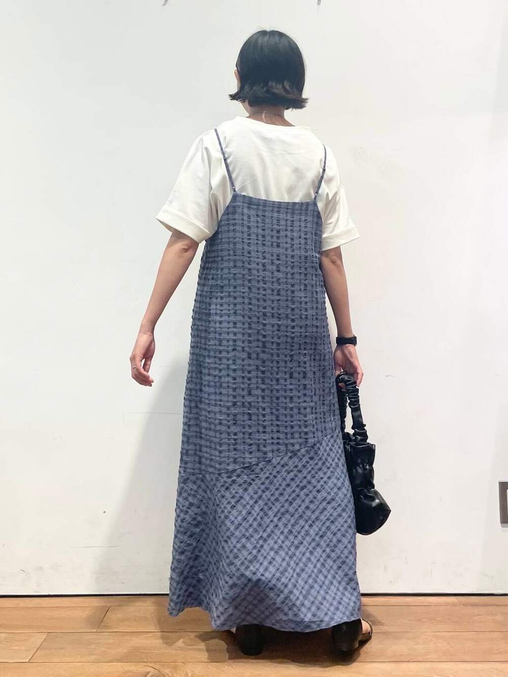 ブラック系のサンダル、ホワイト系のTシャツ/カットソー、ブラック系のハンドバッグを着用したレディースの夏コーディネートの6枚目の写真