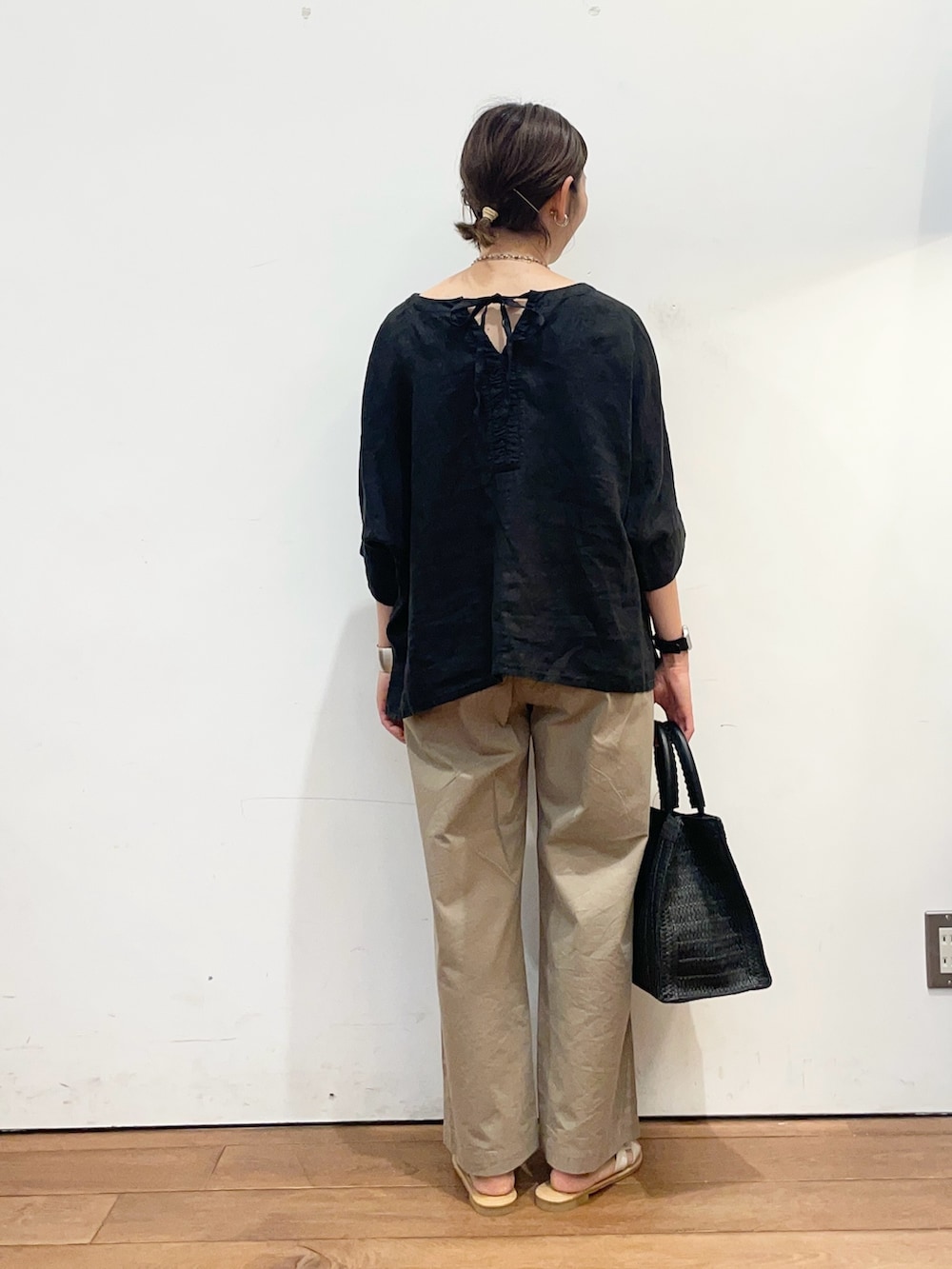 ブラック系のシャツ/ブラウス、ベージュ系のその他パンツ、ブラック系のハンドバッグを着用したレディースの夏コーディネートの4枚目の写真