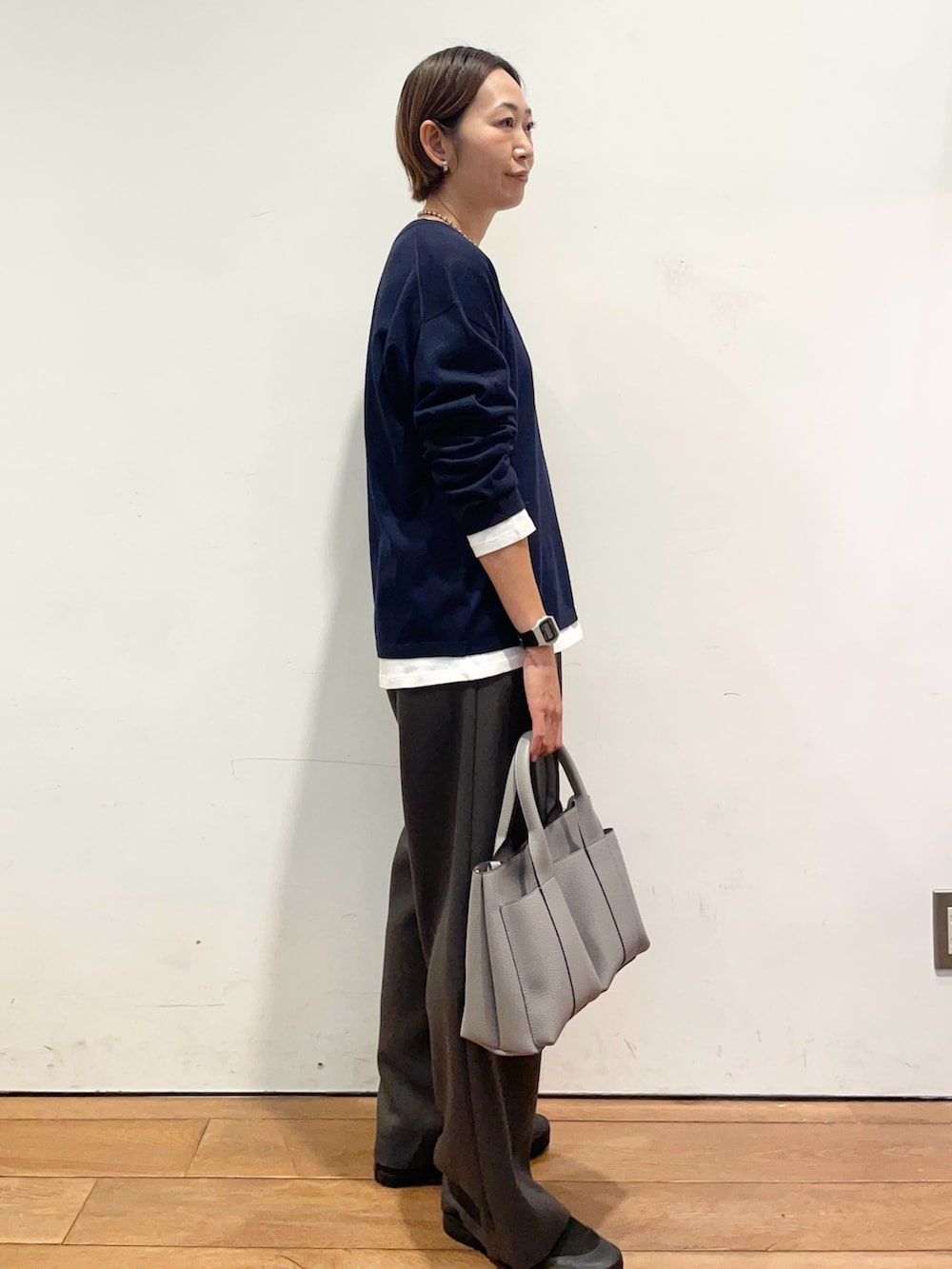 ブルー系のニット/セーター、グレー系のトートバッグ、ブラック系のバレエシューズを着用したレディースの秋コーディネートの4枚目の写真