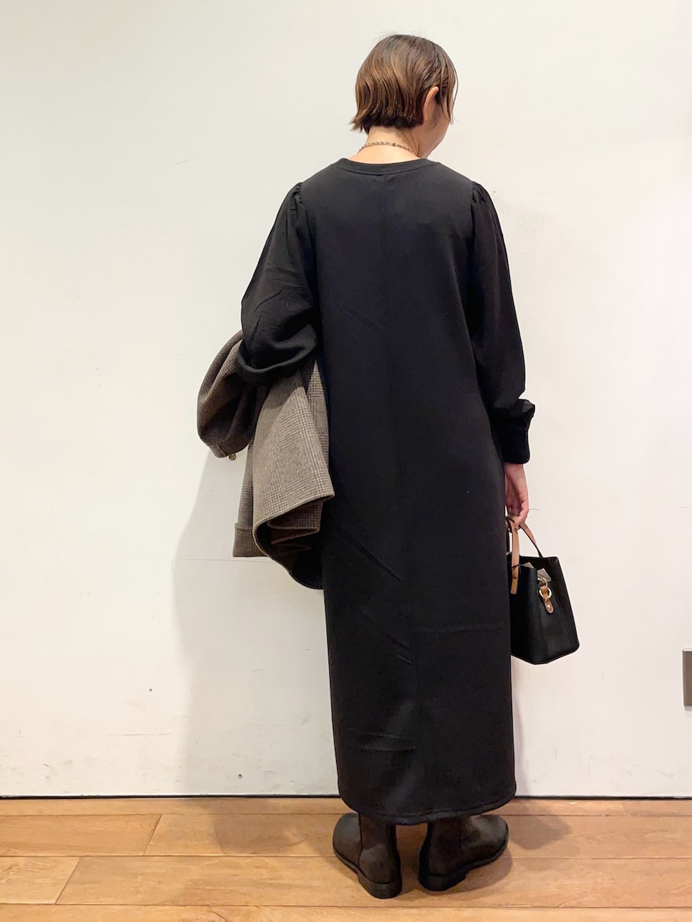 ブラック系のブーツ、ブラック系のハンドバッグ、その他のその他アウターを着用したレディースの秋コーディネートの8枚目の写真