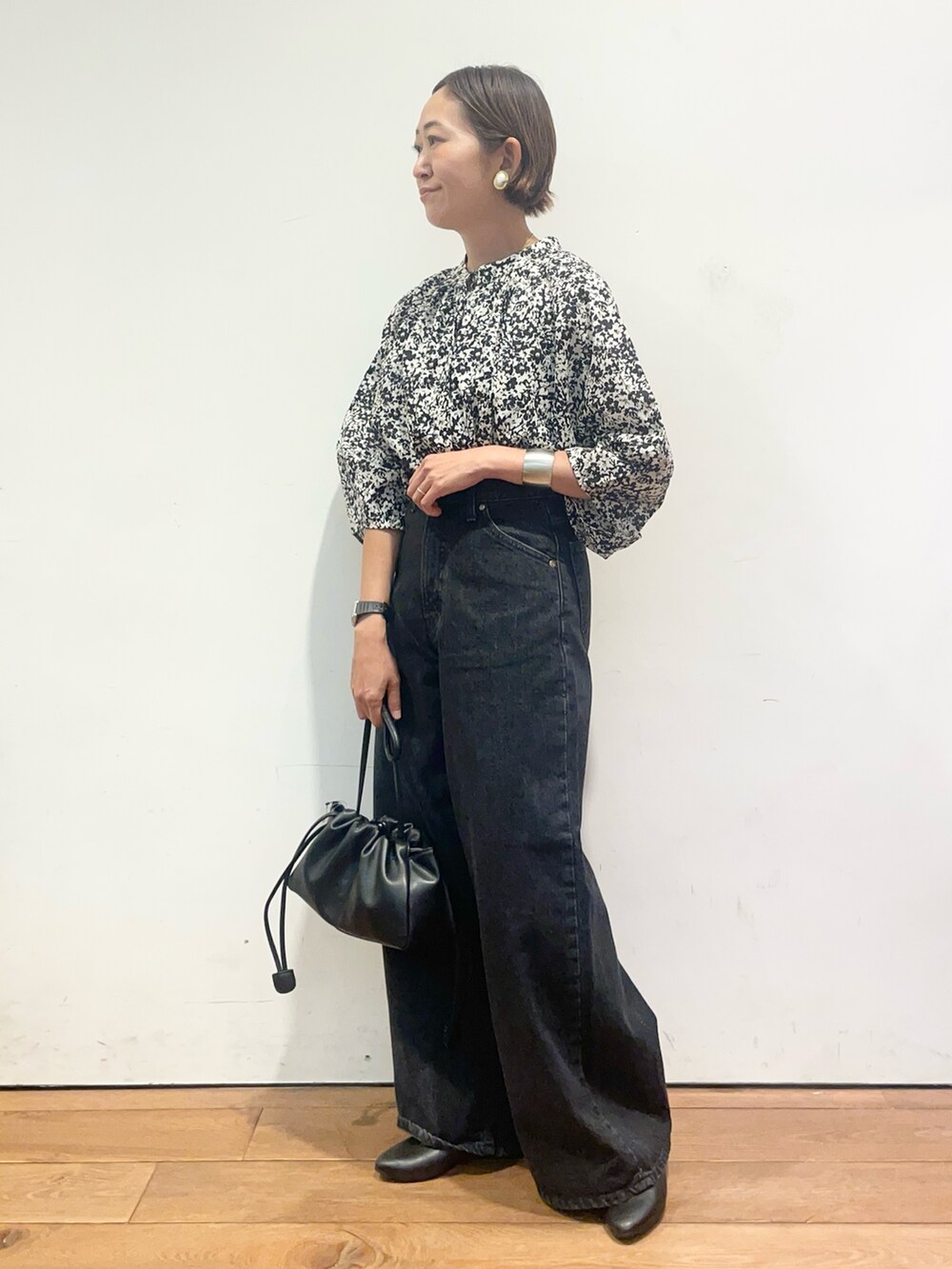 ブラック系のシャツ/ブラウス、ブラック系のデニムパンツ、ブラック系のショルダーバッグを着用したレディースの夏コーディネートの4枚目の写真