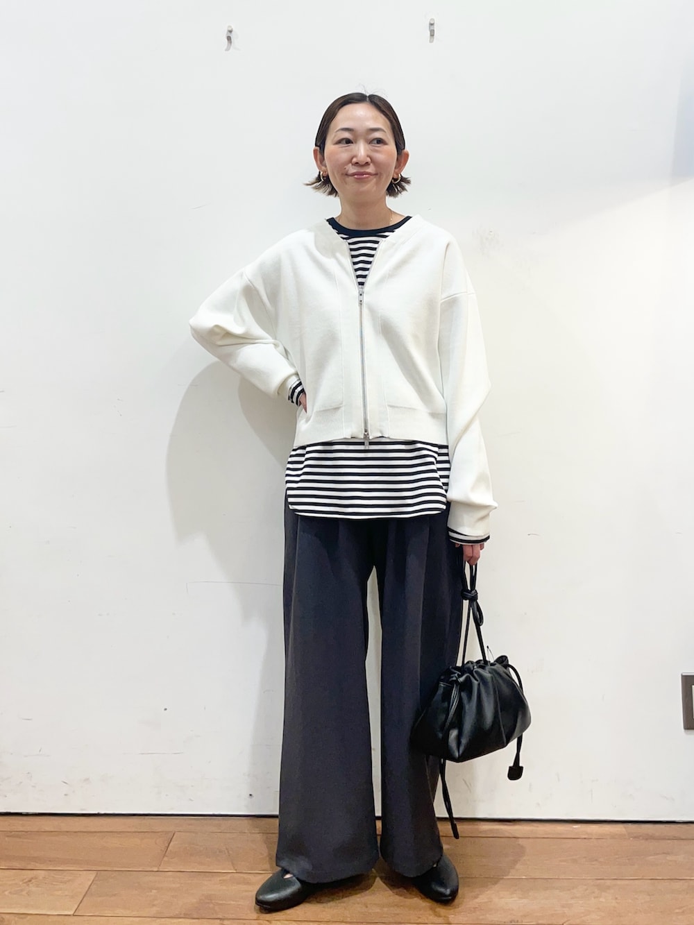 ホワイト系のカーディガン/ボレロ、ホワイト系のTシャツ/カットソー、グレー系のその他パンツを着用したレディースの春コーディネートの2枚目の写真