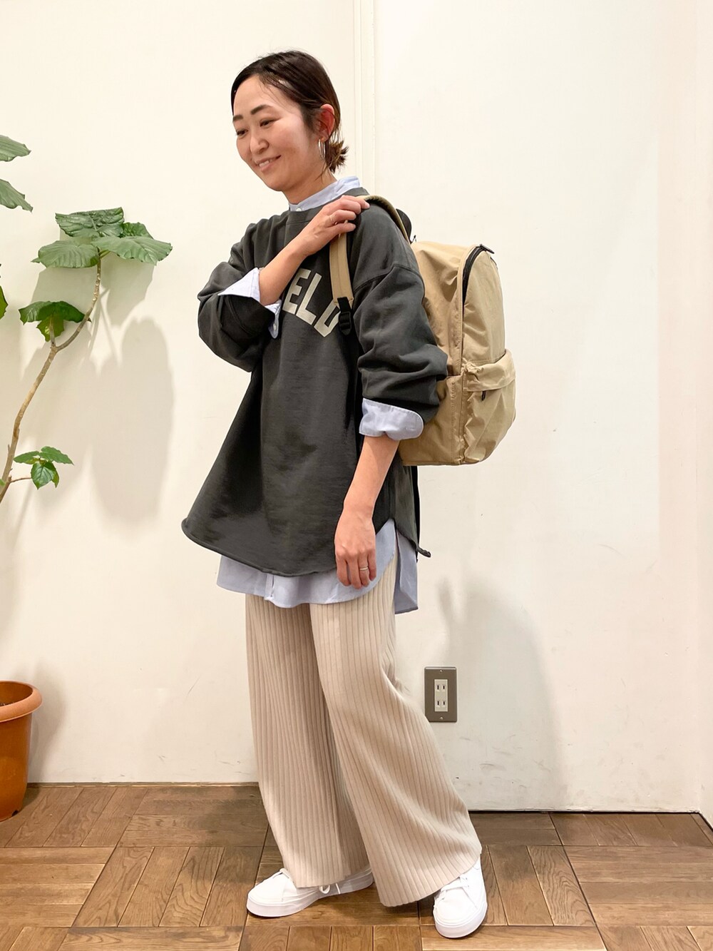 ブルー系のシャツ/ブラウス、グレー系のスウェット、ベージュ系のバックパック/リュックを着用したレディースの冬コーディネートの4枚目の写真