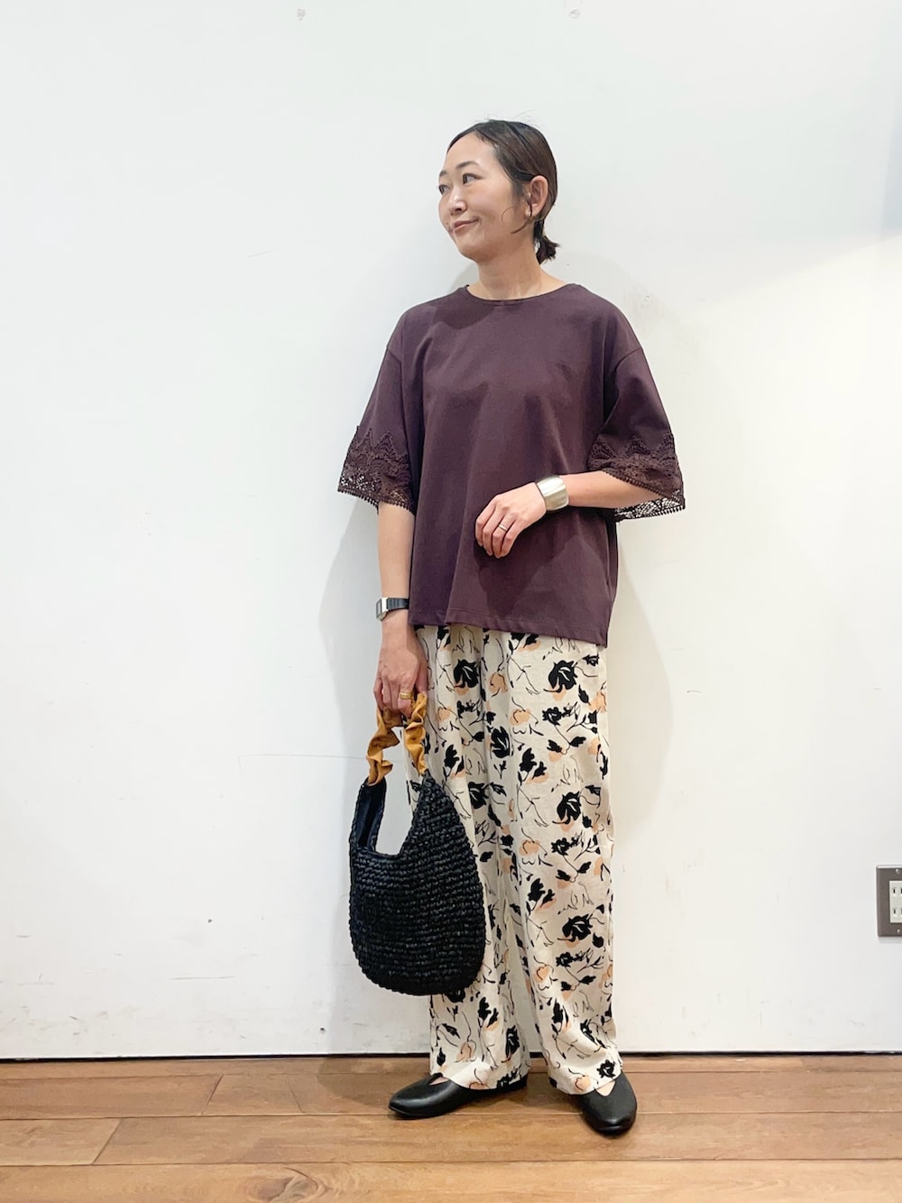 ブラウン系のTシャツ/カットソー、ベージュ系のその他パンツ、オレンジ系のかごバッグを着用したレディースの春コーディネートの2枚目の写真