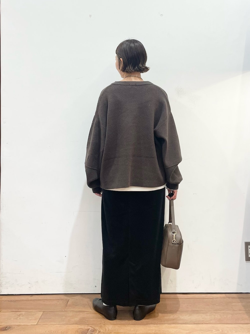 ブラウン系のブルゾン、ホワイト系のTシャツ/カットソー、ブラウン系のショルダーバッグを着用したレディースの秋コーディネートの5枚目の写真