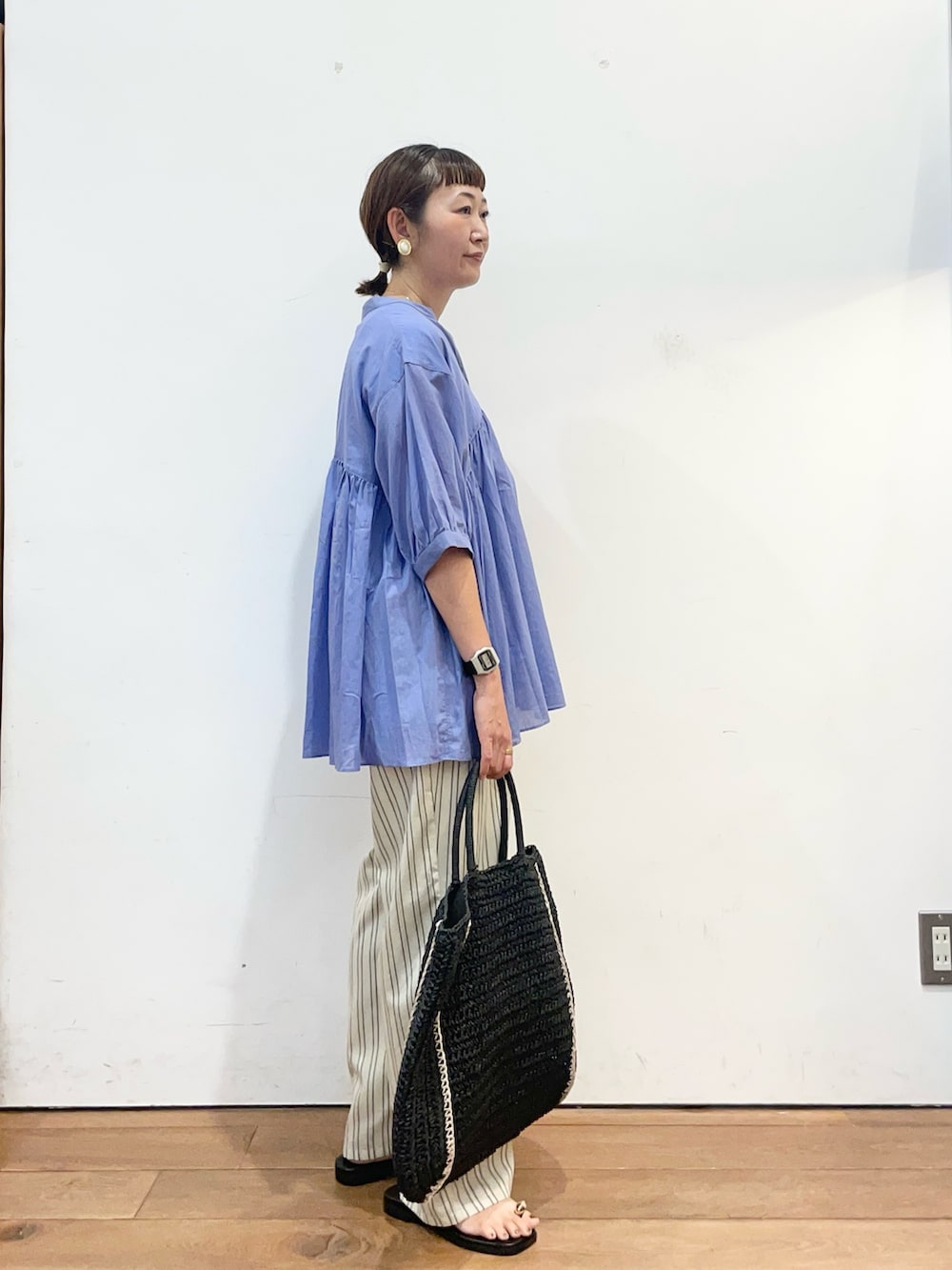 ブルー系のシャツ/ブラウス、ブラック系のサンダル、ベージュ系のその他パンツを着用したレディースの夏コーディネートの3枚目の写真