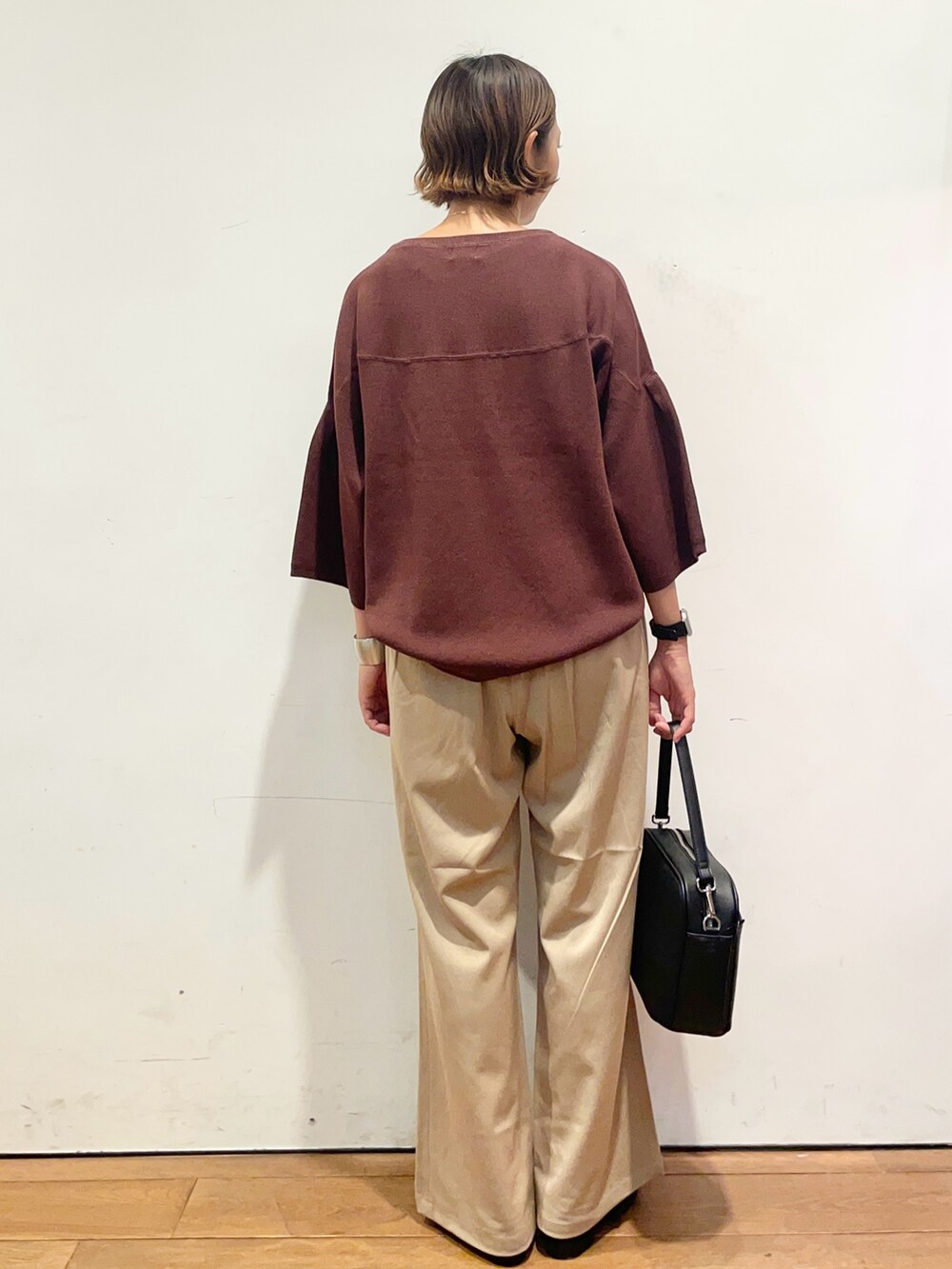 ベージュ系のその他パンツ、ブラウン系のニット/セーター、ブラック系のショルダーバッグを着用したレディースの秋コーディネートの5枚目の写真