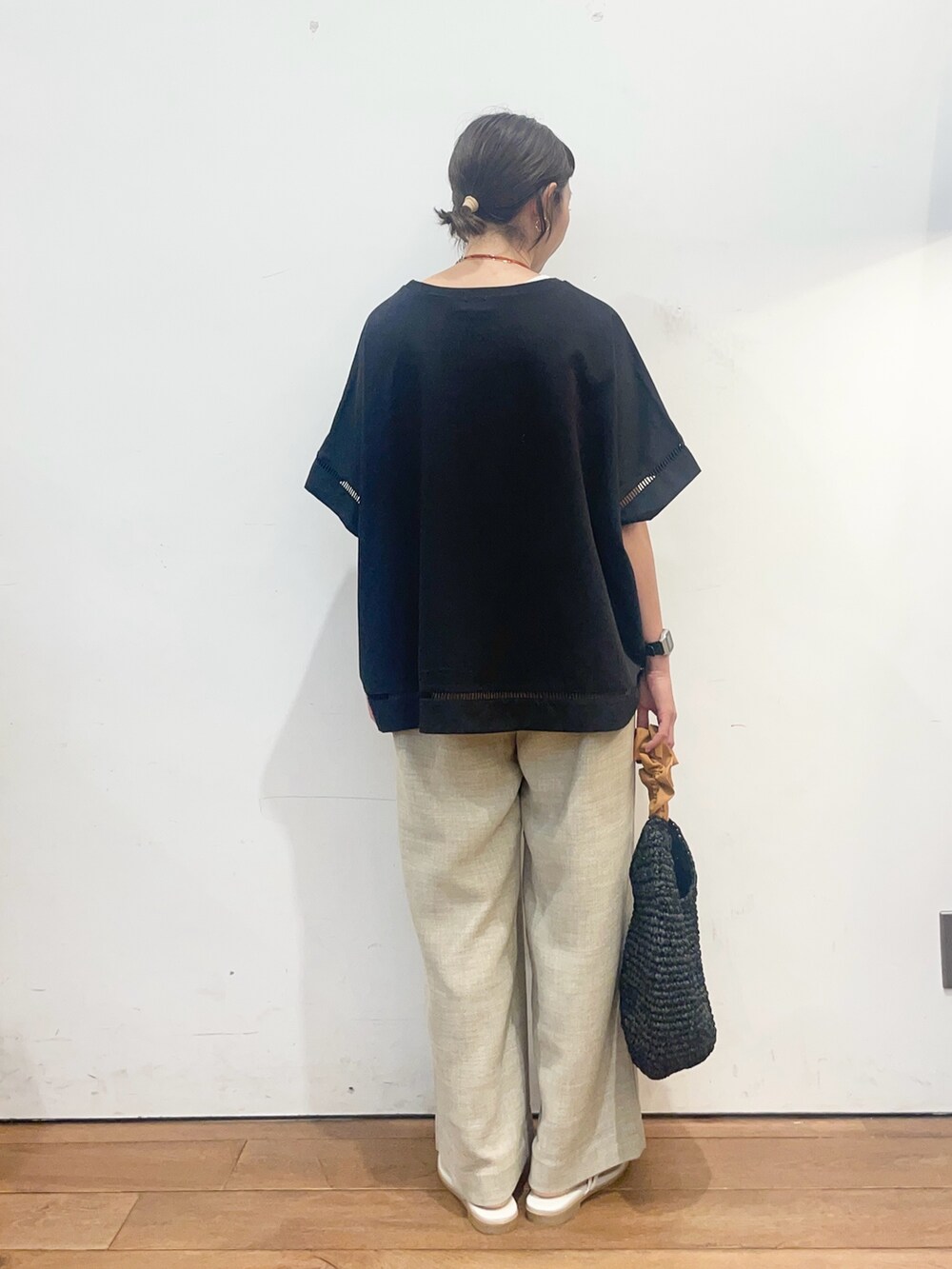 ブラック系のTシャツ/カットソー、ベージュ系のその他パンツ、オレンジ系のかごバッグを着用したレディースの夏コーディネートの4枚目の写真