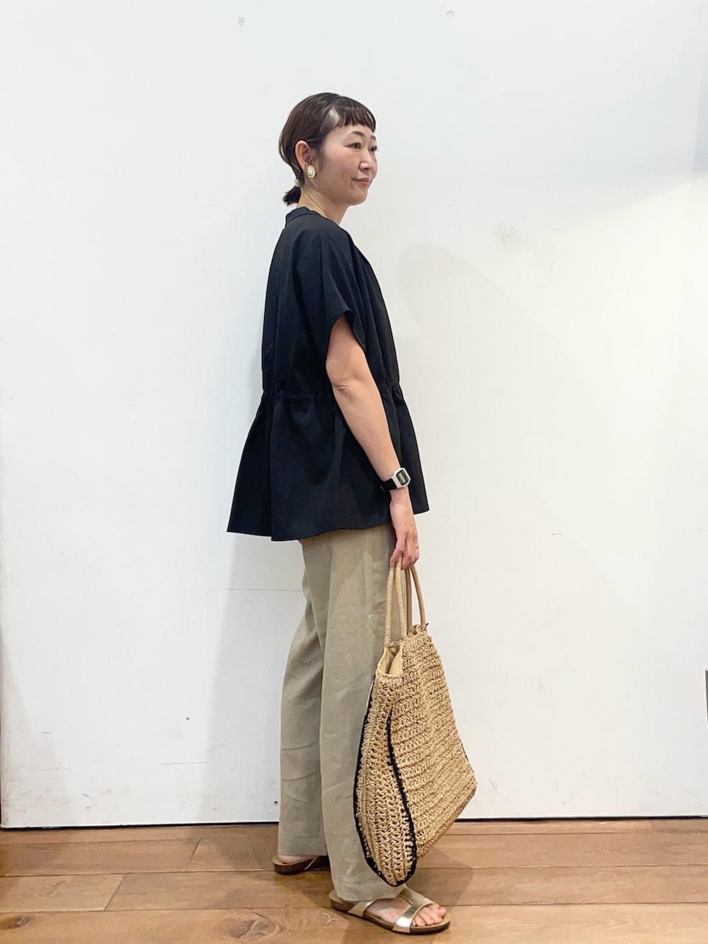 ブラック系のシャツ/ブラウス、ベージュ系のその他パンツ、ゴールド系のサンダルを着用したレディースの夏コーディネートの3枚目の写真