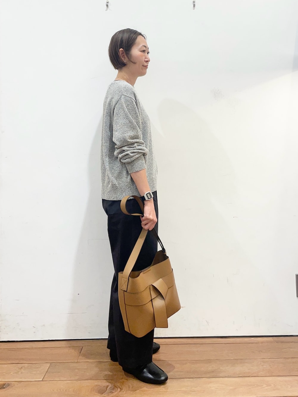 ブラック系のニット/セーター、ブラック系のその他パンツ、ブラック系のローファーを着用したレディースの春コーディネートの4枚目の写真