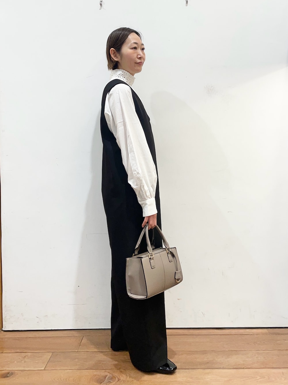 ブラック系のその他パンツ、ホワイト系のシャツ/ブラウス、グレー系のハンドバッグを着用したレディースの冬コーディネートの4枚目の写真