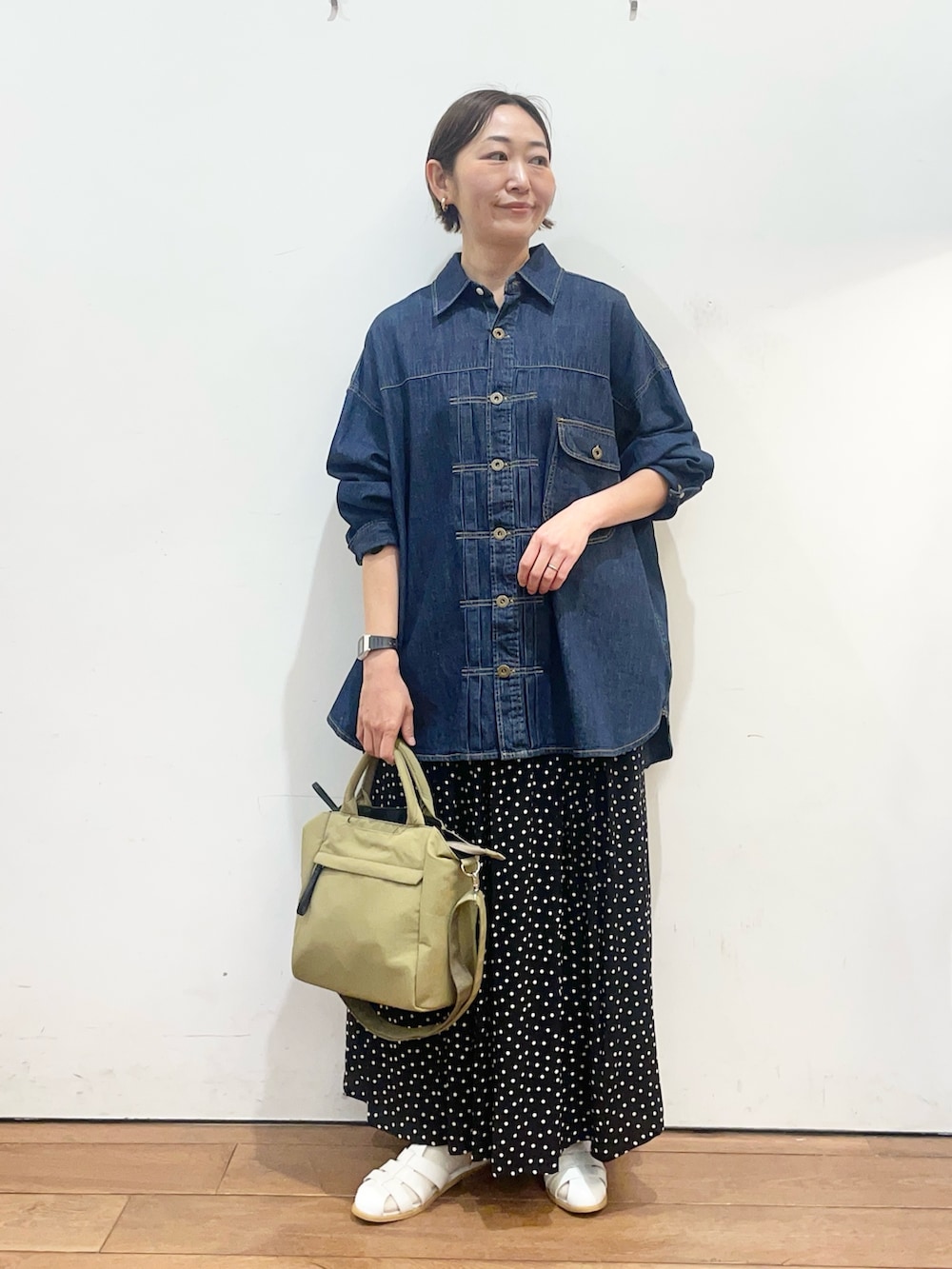 ブルー系のシャツ/ブラウス、ホワイト系のサンダル、ブラック系のスカートを着用したレディースの春コーディネートの2枚目の写真