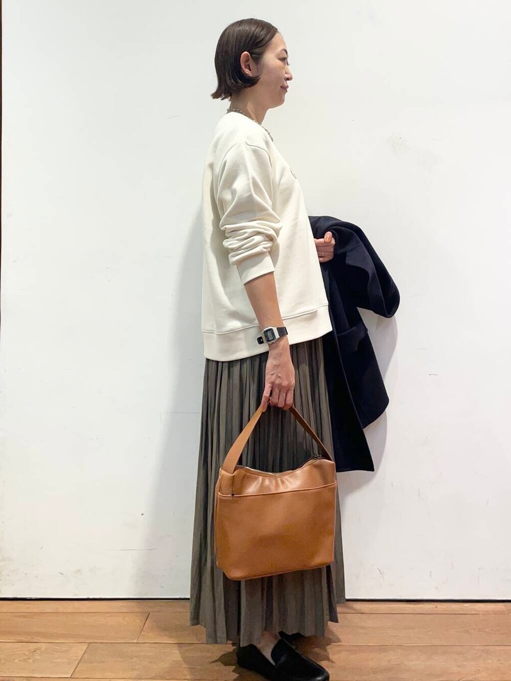 ブルー系のその他アウター、イエロー系のショルダーバッグ、ベージュ系のスカートを着用したレディースの秋コーディネートの6枚目の写真