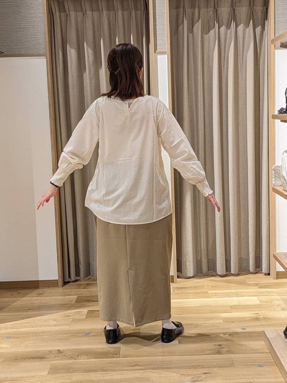 ベージュ系のスカート、ベージュ系のテーラードジャケット、ブラック系のトートバッグを着用したレディースの冬コーディネートの5枚目の写真