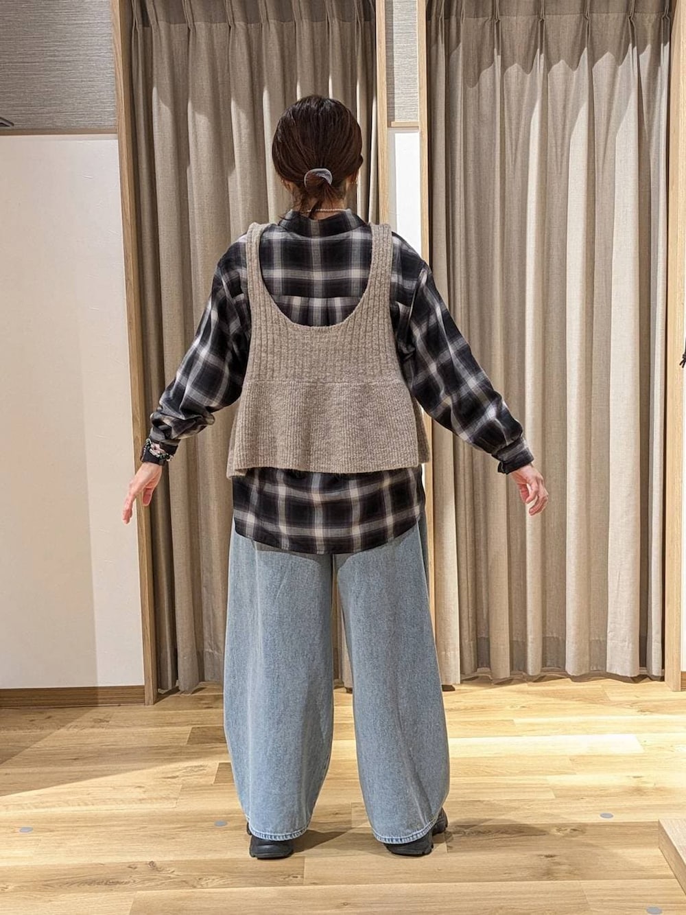 ブラック系のブーツ、その他のシャツ/ブラウス、ベージュ系のベストを着用したレディースの冬コーディネートの2枚目の写真