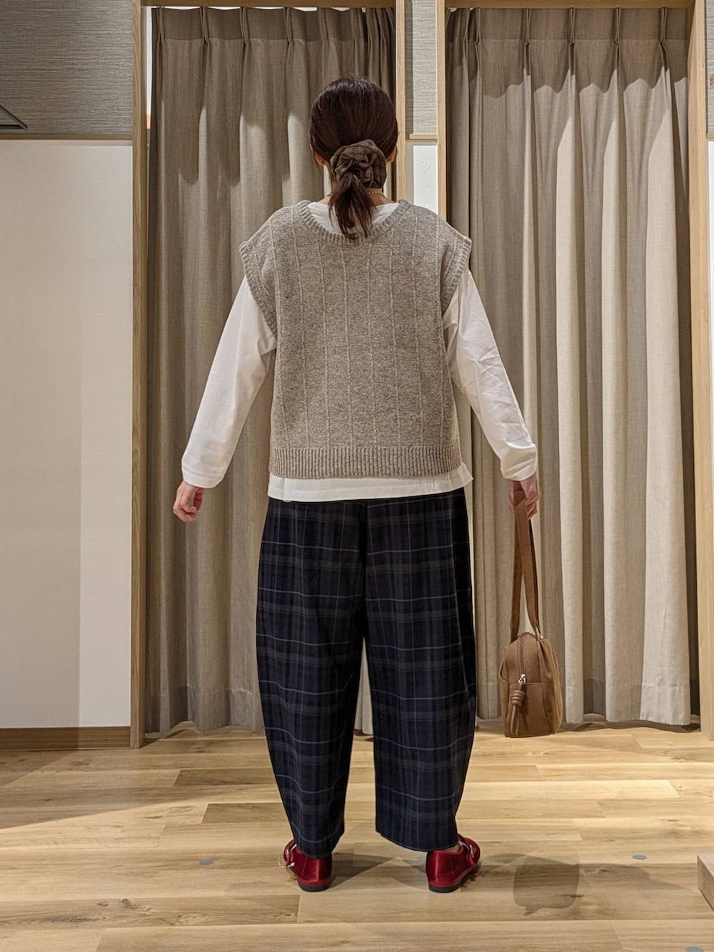 ブラウン系のショルダーバッグ、レッド系のその他シューズ、ホワイト系のTシャツ/カットソーを着用したレディースの秋コーディネートの3枚目の写真