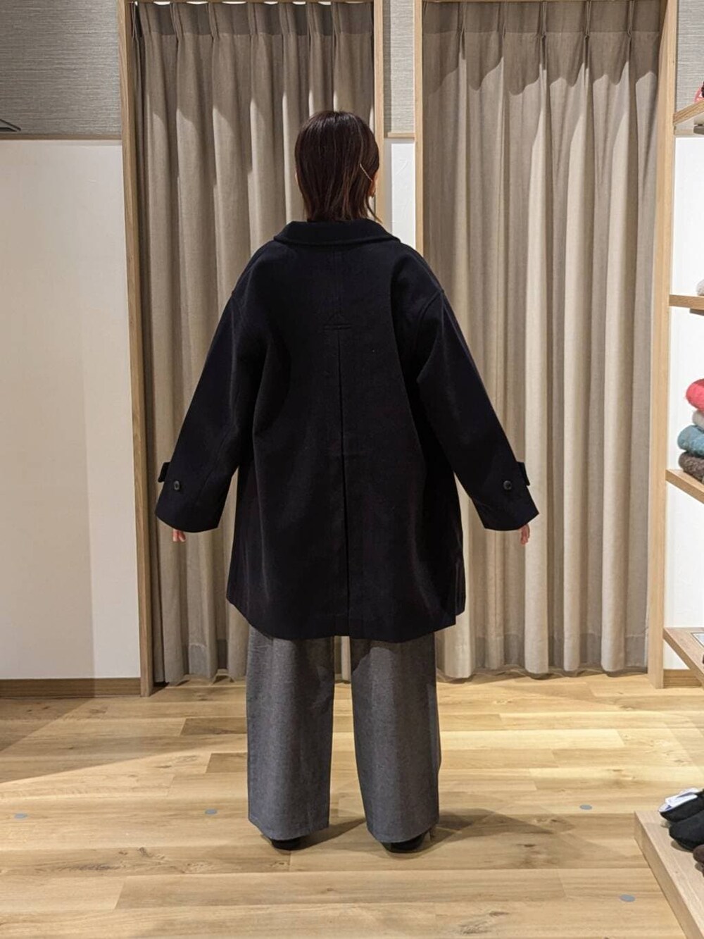 ブルー系のその他アウター、グレー系のその他パンツ、ブラック系のトートバッグを着用したレディースの冬コーディネートの2枚目の写真