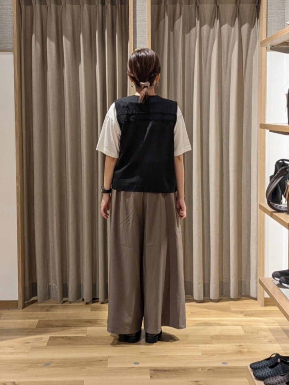 ブラック系のショルダーバッグ、ホワイト系のTシャツ/カットソー、ブラウン系のローファーを着用したレディースの秋コーディネートの4枚目の写真