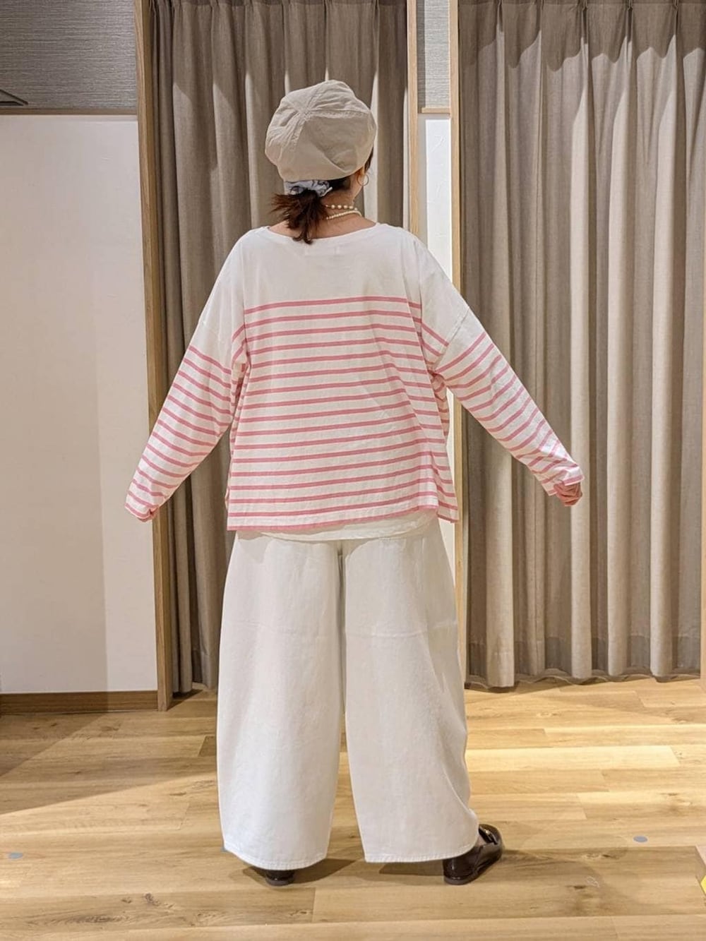 ホワイト系のデニムパンツ、ブラウン系のローファー、ベージュ系のトートバッグを着用したレディースの春コーディネートの2枚目の写真