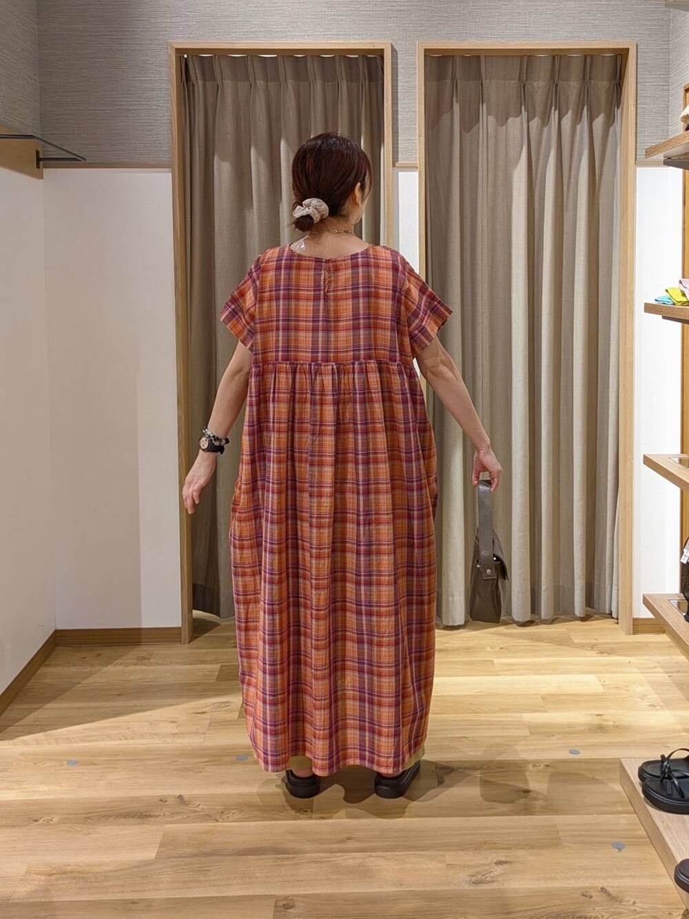 ブラウン系のサンダル、ベージュ系のその他パンツ、オレンジ系のワンピースを着用したレディースの夏コーディネートの2枚目の写真
