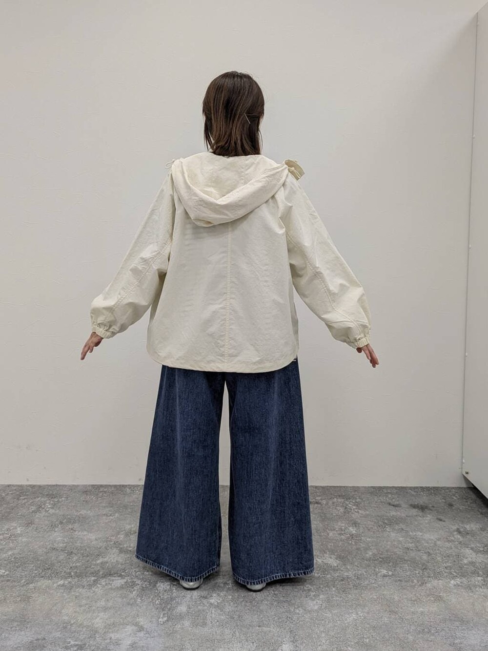 その他のパンプス、ブルー系のデニムパンツ、その他のTシャツ/カットソーを着用したレディースの冬コーディネートの2枚目の写真