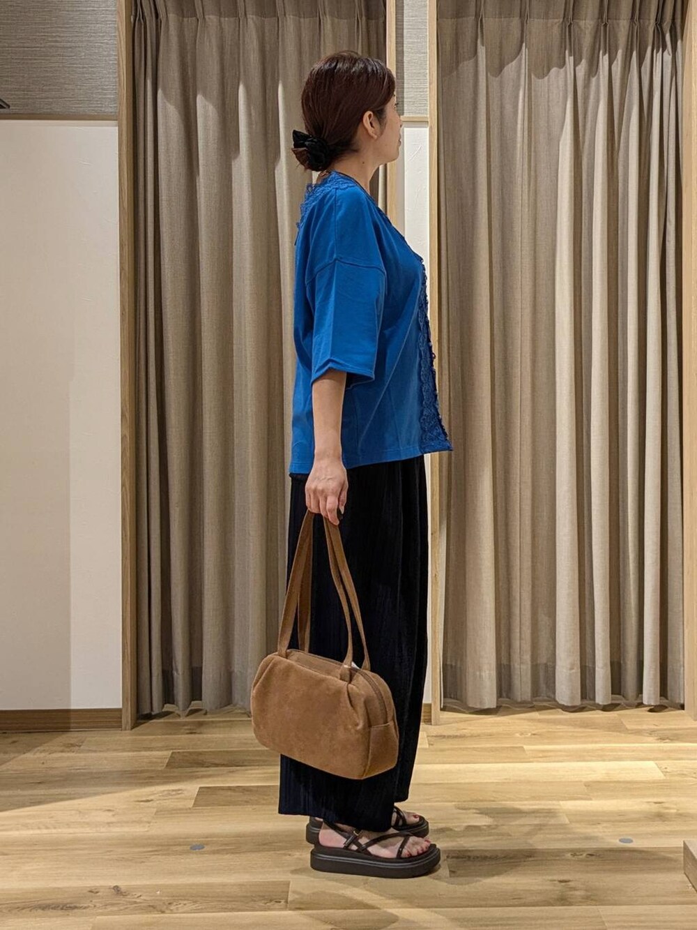 ブラウン系のショルダーバッグ、ブルー系のその他パンツ、ブラウン系のサンダルを着用したレディースの夏コーディネートの2枚目の写真