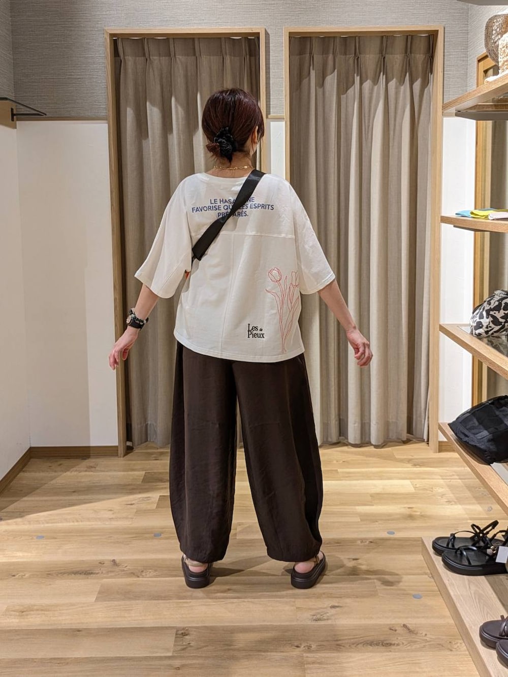 ベージュ系のサンダル、ブラウン系のその他パンツ、ホワイト系のTシャツ/カットソーを着用したレディースの夏コーディネートの2枚目の写真