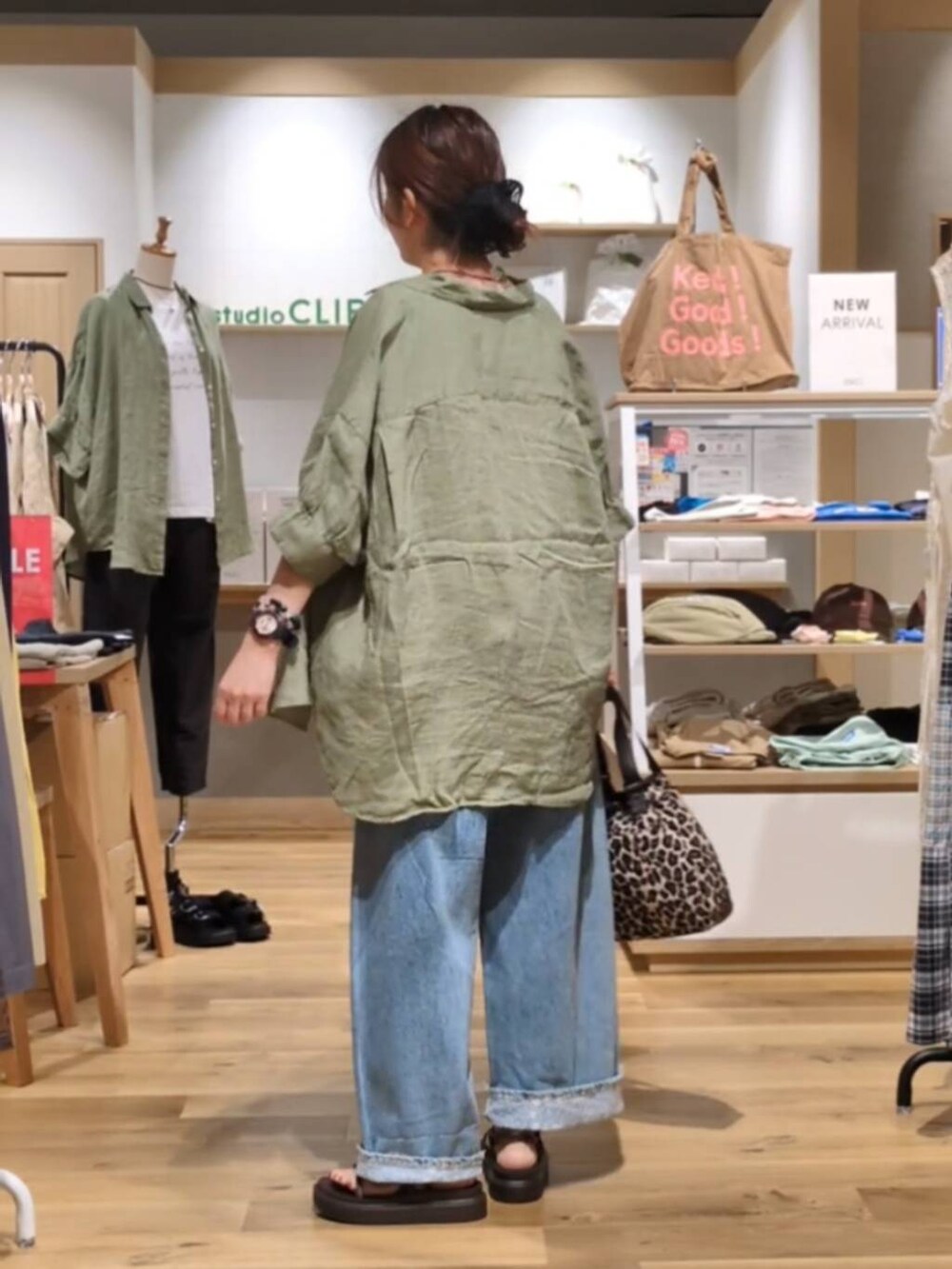 ブルー系のデニムパンツ、ベージュ系のシャツ/ブラウス、ブラウン系のサンダルを着用したレディースの夏コーディネートの3枚目の写真